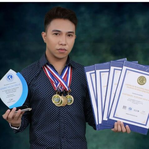 Photo of Glenbert Avelino with their Hai English certificates, medals, and plaques