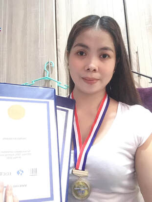 Photo of Jhonnah Caponpon with their Hai English certificates and medals